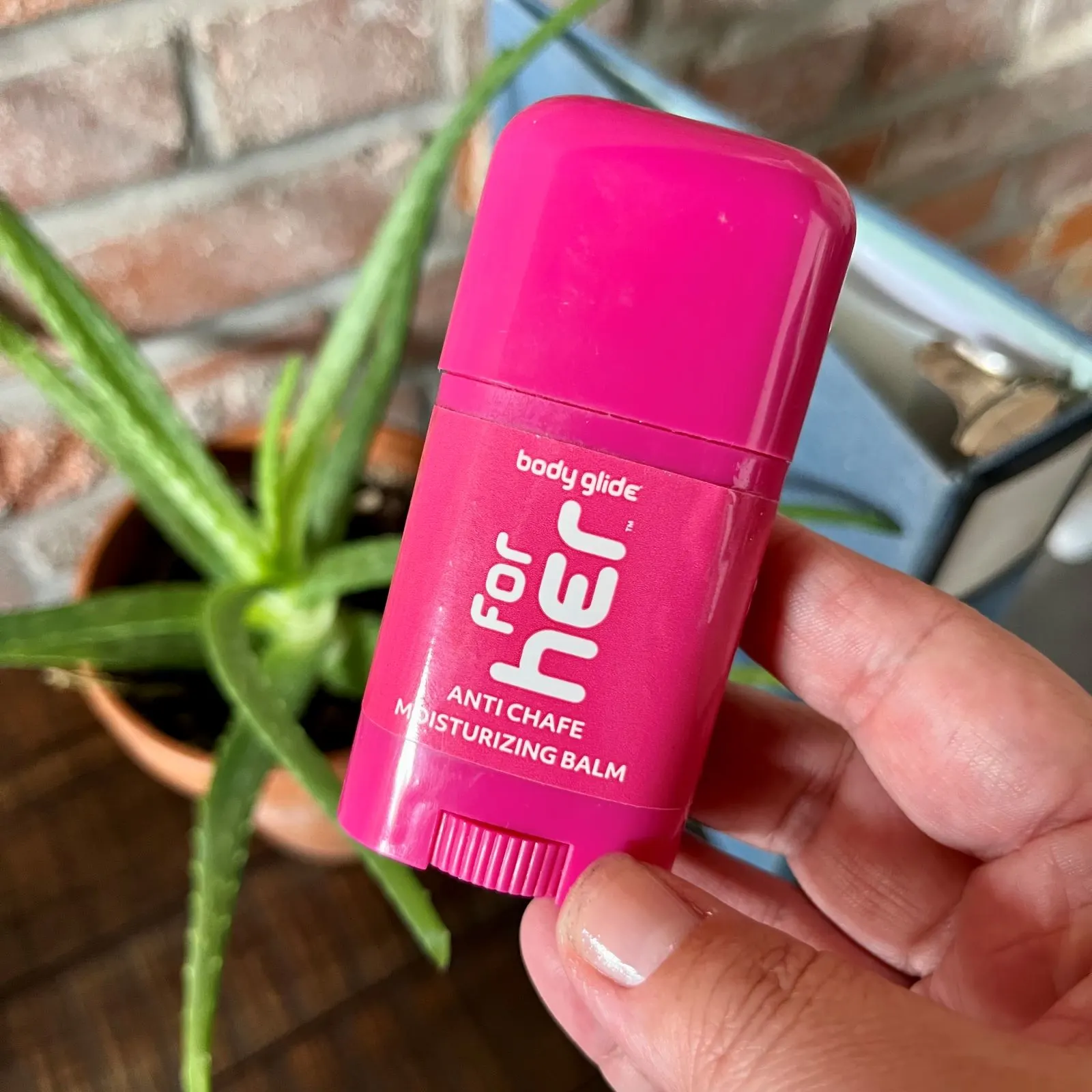 photo of a pink deodorant like container of body glide and anti chafe moisturizing balm