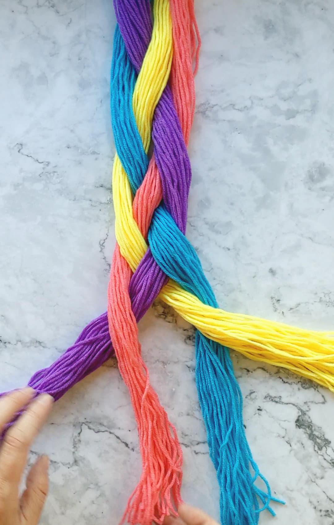 hands braiding a four strand braid