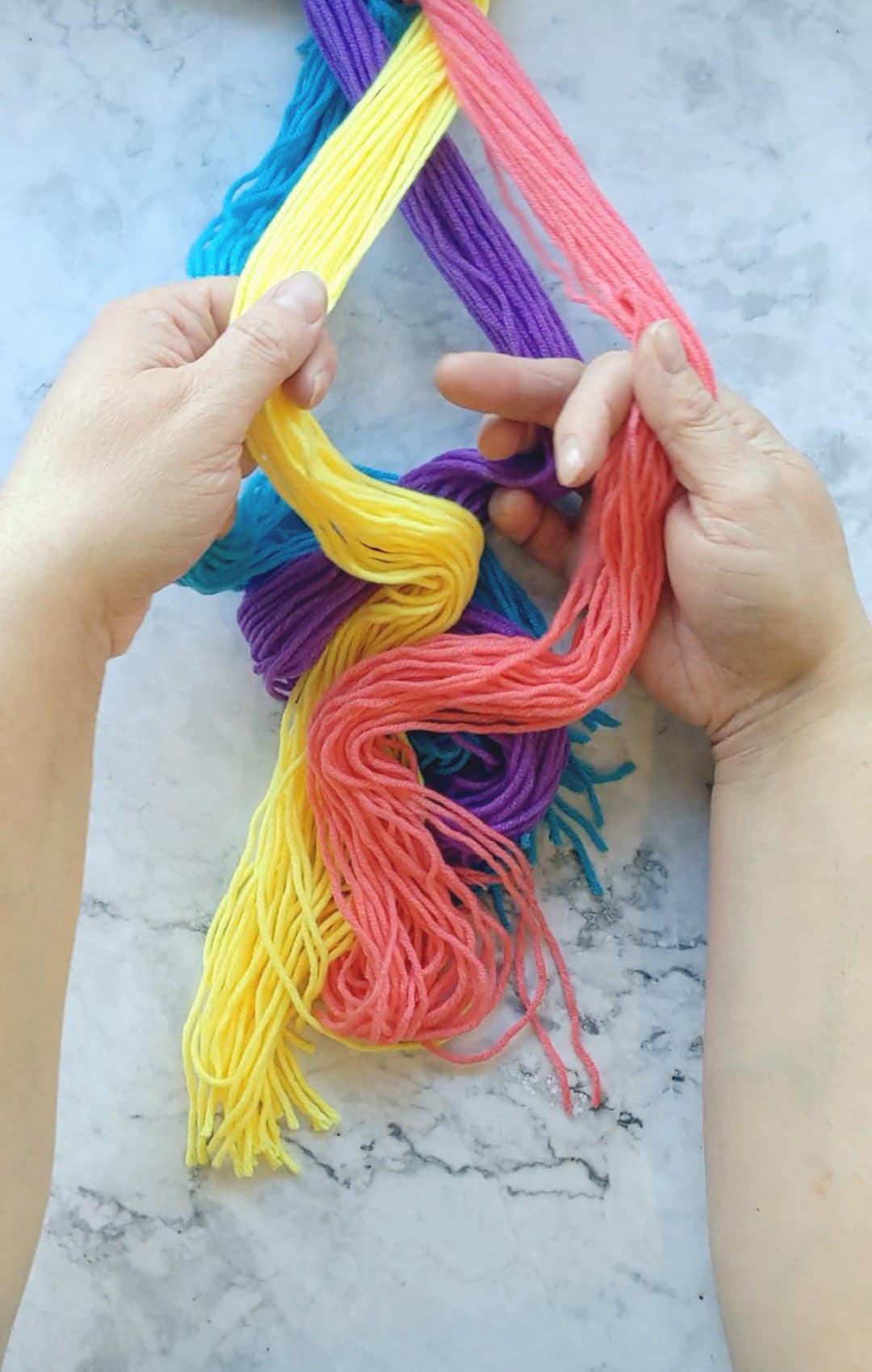 hands braiding a four strand braid