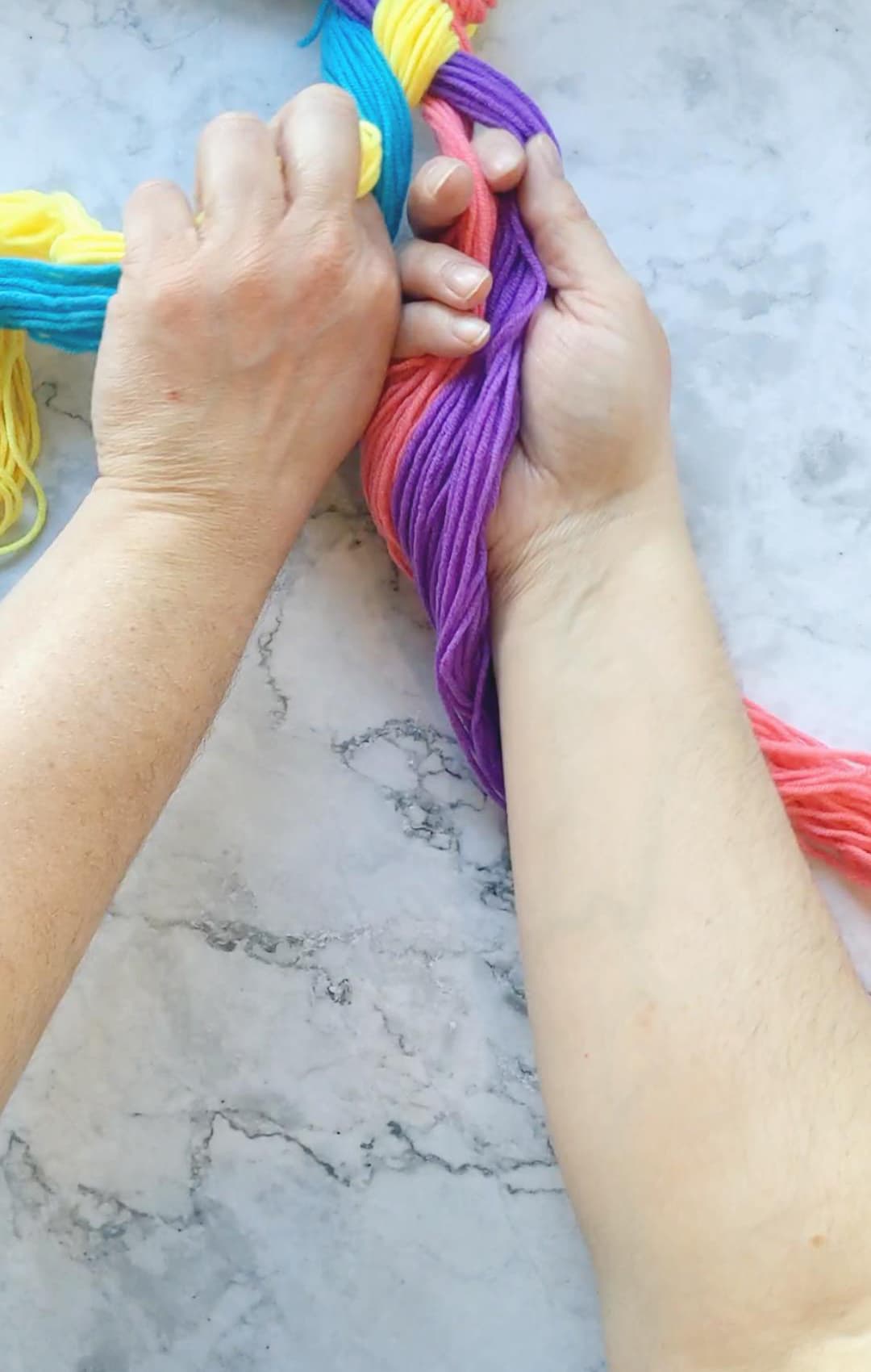 hands braiding a four strand braid