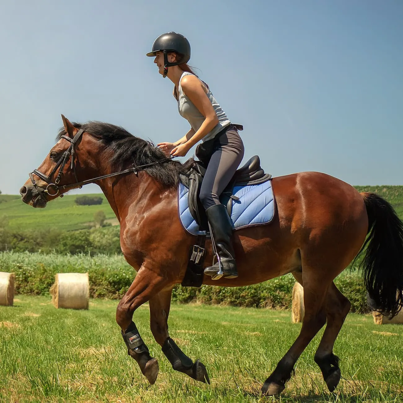 A girl riding a horse in a field.