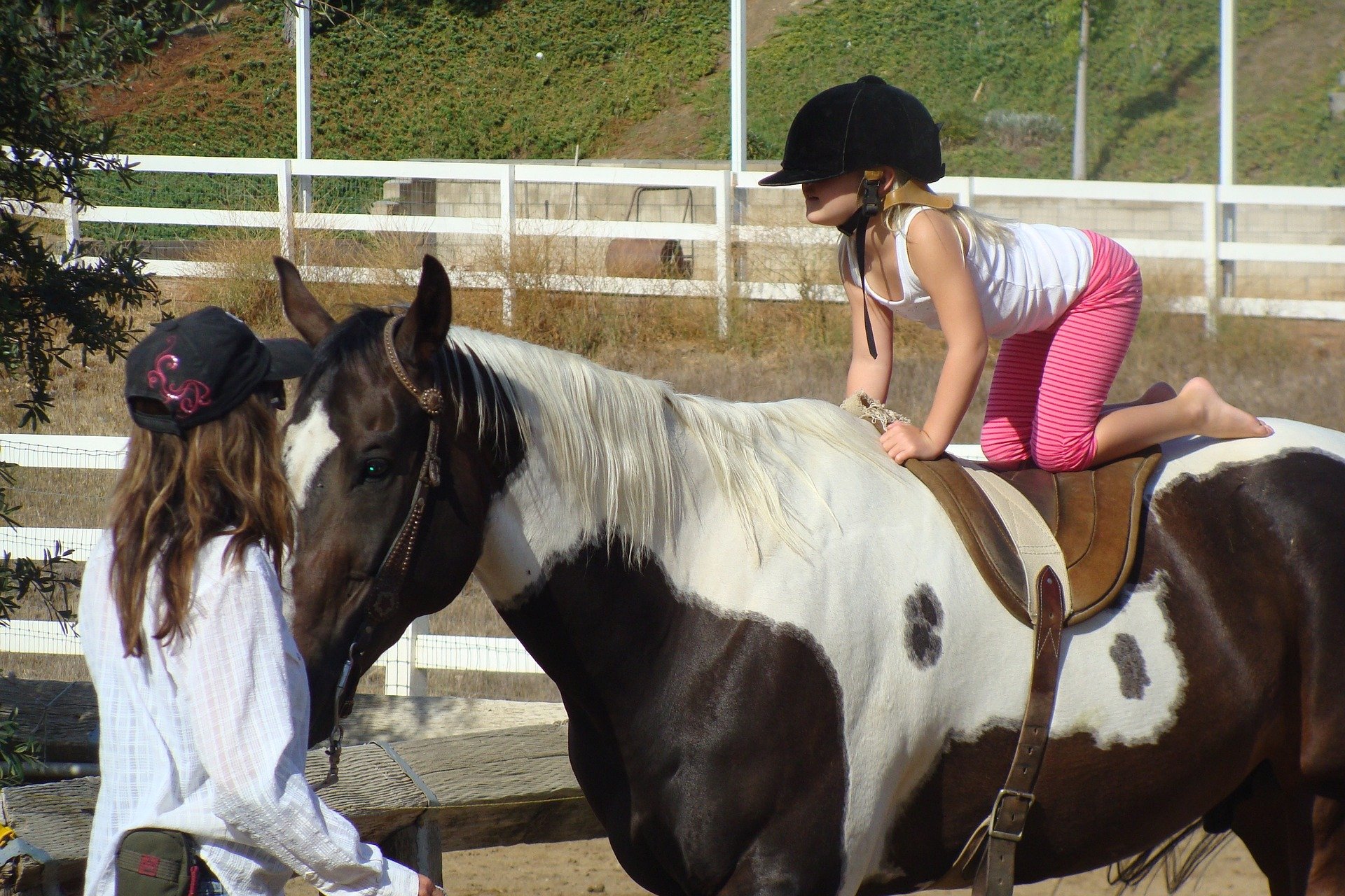 A young girl in horse vaulting lesson.