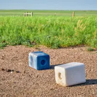 salt blocks with trace minerals for cattle sit in a field in the Midwest USA.