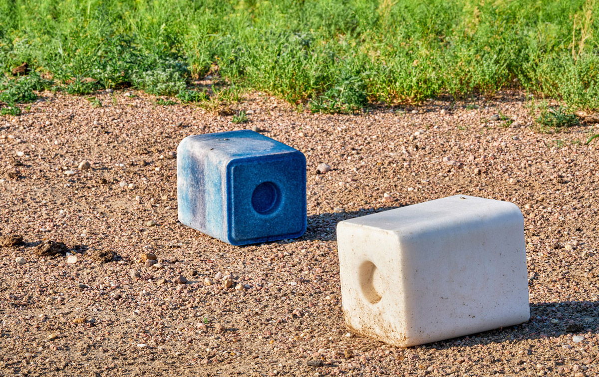 salt blocks with trace minerals for cattle sit in a field in the Midwest USA.